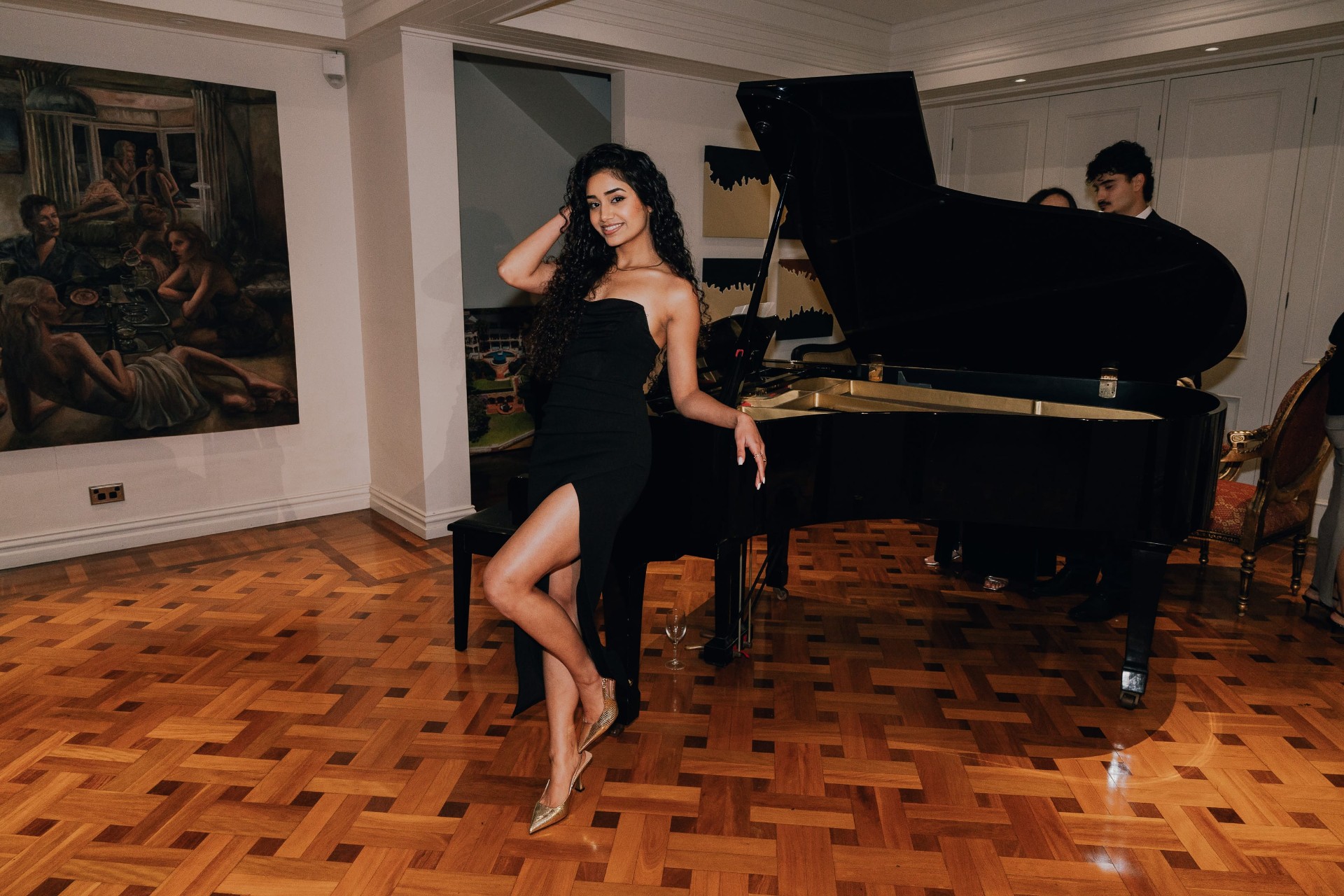 A pianist plays for guests in the drawing room